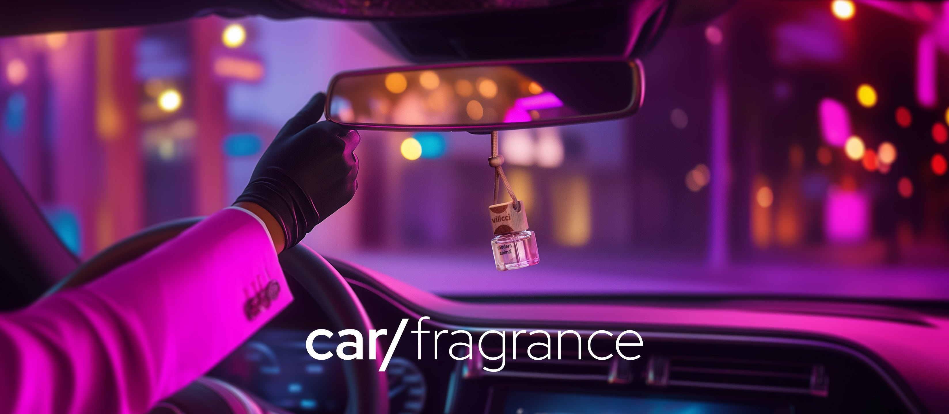 Modern Animal car diffuser by Vilicci hanging from rearview mirror in a night-lit vehicle interior